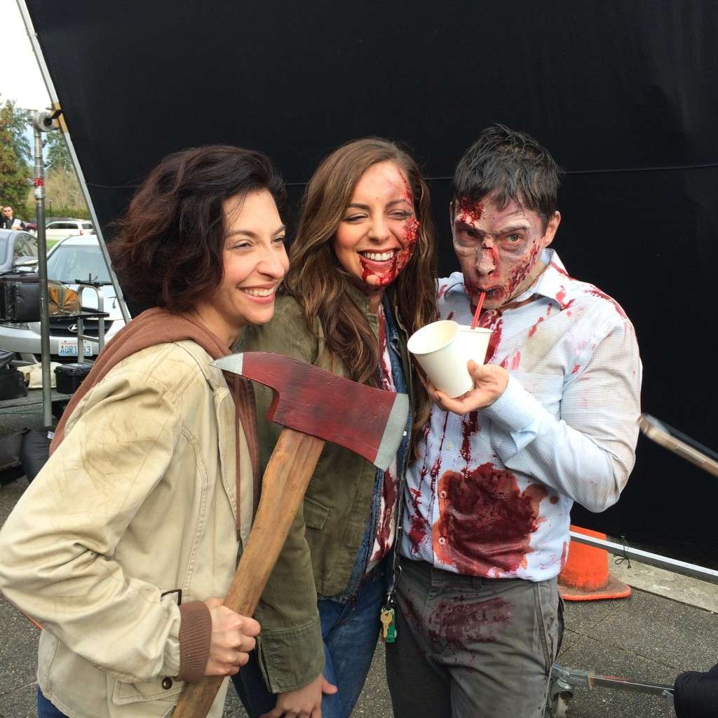 Cast take a break from filming on the steps.